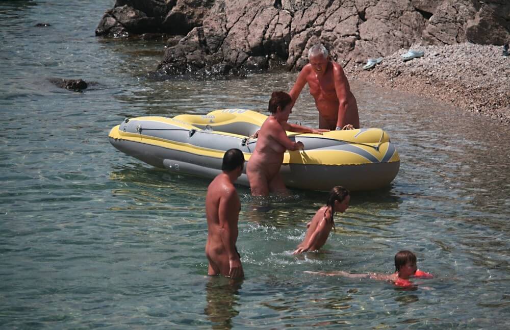 Lone Nudist in Yellow Boat photos - A nudist values the connection with nature and the human body